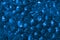 Transparent blue hydrogel balls. Blue water gel balls with bokeh. Polymer gel Silica gel. Liquid crystal ball with reflection.