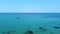 Transparent blue open sea with sailboat. Aerial view