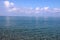 Transparent blue sea, blue sky, clouds are reflected on the water surface