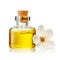 Transparent bottle with cork stopper and flower with yellow essential oil isolated