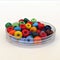 Transparent bowl of colorful glass beads for crafting and jewelry making. DIY kit. Hobby, handmade jewelery