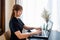 transparent businesswoman dressed in black uses a laptop to work happily
