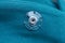 transparent button on green woolen cloth on clothes
