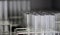 Transparent clear test tubes on racks, clean glasswares on the laboratory shelf for measuring solution or solvent in science.