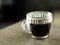 Transparent coffee mug Resting on a gray wooden table blurred background