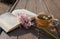 Transparent cup of tea and blooming hyacinth on an open book