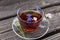 A transparent cup with tea with herbs and small flowers. Health and detox cleansing