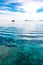 Transparent Deep Blue Sea and a Tourist Boat