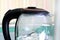 Transparent electric kettle with boiling water inside. Top part