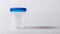 Transparent empty urine analysis container with a blue lid. Clear specimen cup on a white background. Concept of