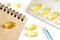 Transparent fish oil capsules, notepad, blister and fountain pen lie on a white surface. Vitamin D, prescription and prevention of