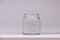 Transparent glass bottle jar against white background for branding mock up. For kitchen, cafe, retail store template scene;