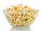 Transparent glass bowl with popcorn isolated on a white