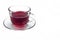 Transparent glass cup with Hibiscus tea on a saucer isolated