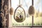 Transparent glass Easter eggs with Springtime decor, dry plants, flowers and small eggs. Glass eggs hang on hemp cord by window.