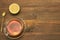 Transparent Glass Teacup And Gold Teaspoon On Rough Wood Table