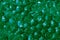 Transparent green hydrogel balls. Green water gel balls with bokeh. Polymer gel Silica gel. Liquid crystal ball with reflection.