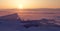 Transparent ice floe on a hummock field on the frozen Siberian Lake Baikal at sunset in winter.