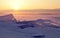 Transparent ice floe on a hummock field on the frozen Siberian Lake Baikal at sunset in winter.