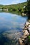 Transparent lake with green shore.