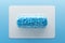 Transparent pill with blue candy hearts