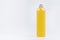 Transparent plastic tall thin bottle with orange drink, cooking oil or cosmetic produce, silver cap mockup on white background.