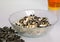 A transparent plate with husks from sunflower seeds. And a cup of tea