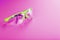 Transparent polycarbonate safety glasses on a pink background