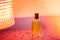 Transparent rectangular bottle of perfume on golden neon background. Fashion style perfumery template. Copy space