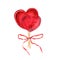 Transparent red caramel in the shape of heart decorated with red ribbon. Bouquet of candies, bonbons, lollipop, sugar caramels on