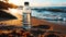 Transparent reusable water bottle on sandy beach with ocean backdrop emphasizing environmental awareness and sustainable lifestyle