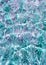 Transparent ripple water texture in a summer sea, ocean or swimming pool. Clear shiny textured surface under sunlight.