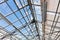 Transparent roof of contemporary greenhouse under bright sky