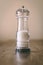 Transparent salt grinder on top of a wooden table