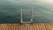 Transparent sea water at dawn. View of the wooden pier and swimming area