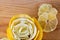 Transparent slices of lemon and peel on a cutting wooden board. Healthy vegetarian food. Macro and shallow depth of field. Closeup