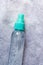 Transparent spray bottle, refillable plastic travel bottle, portable makeup spray bottle on light background