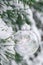 Transparent trendy glass Christmas ball on snowy branch firs in winter forest. Winter holiday background. Copy space