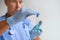 Transparent tube with liquid medicine, a vaccine closeup in the hands of male scientist, doctor, pharmacist, concept scientific