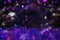 Transparent violet Christmas balls on blurry dark background