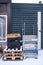 Transport Containers And Metal Trolley Waiting For Collection Outside A Shop