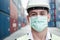 Transport engineer man wearing medical face mask for prevention coronavirus epidemic situation in containers logistic shipping