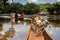 Transport of people across the Mbari river by locally made canoes and by ferry boat.