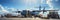 Transport plane at the airport. Workers load goods and cargo onto the plane. Cargo pallets. Air freight