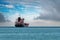 Transport ship traveling in open sea in cloudy weather