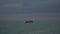 Transport ships in the evening in the ocean. A barge or dry cargo ship is in the roadstead in the sea