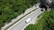 Transport truck with sand exits from tunnel on traffic road. Aerial viewTransport truck and van enter in tunnel on traffic road. A