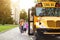 Transportation Concept. Group of children getting on the yellow schoolbus