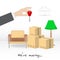 Transportation and home removal. We`re moving. A man`s hand with a key for a new house. Boxes, armchair, lamp, books in antici