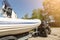 Transportation of inflatable boat on trailer. ATV quadbike moves ship to lake or river shore for launching. Beginning of